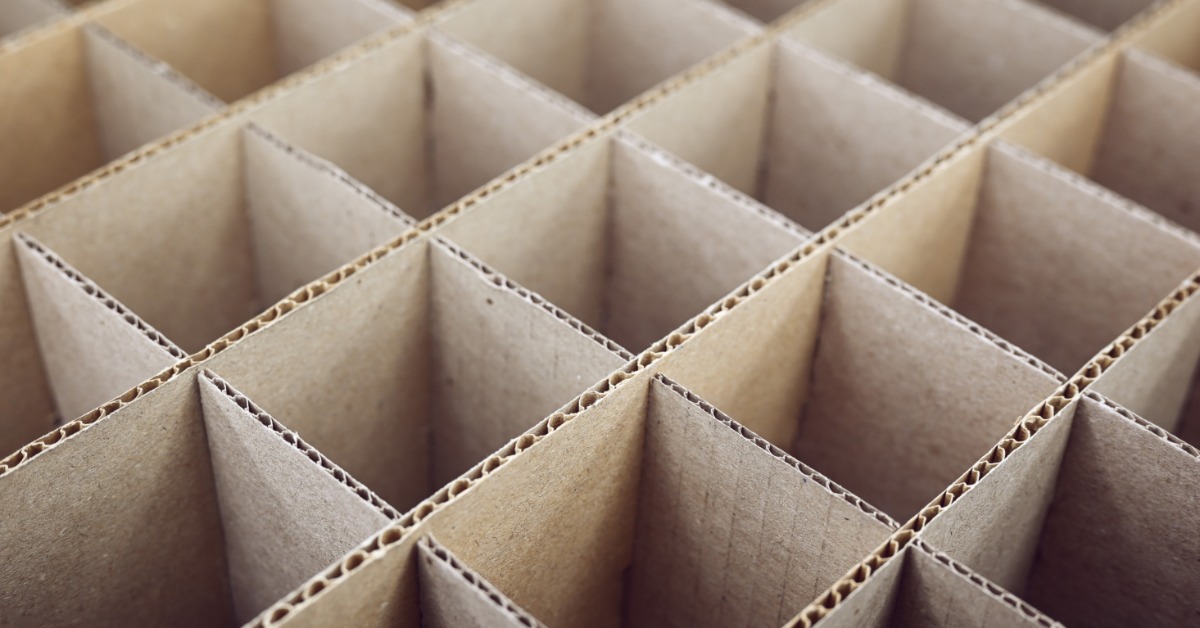 The frame is filled with squares of cardboard. The cardboard forms a grid formation and stretches off screen.