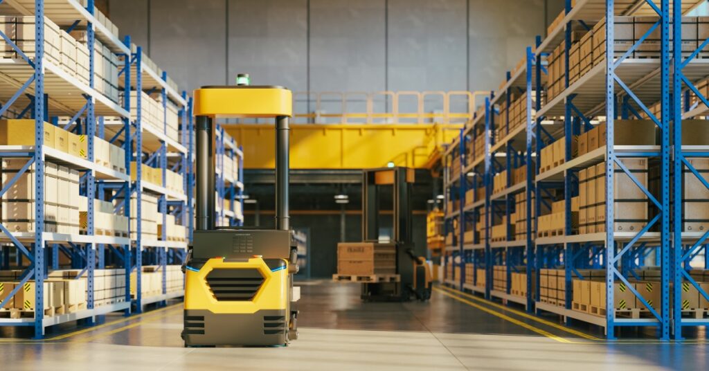 A forklift is in the middle of a warehouse. On either side of the forklift are pallet racks filled with boxes.