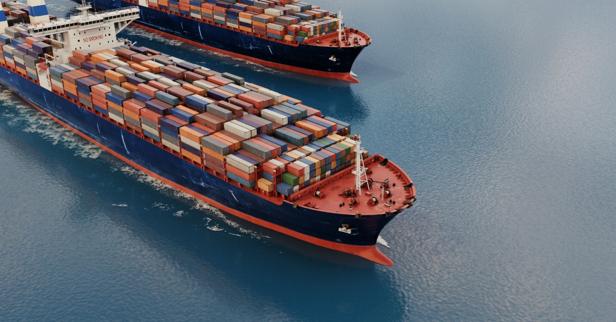Two large container ships are both sailing on a body of water. They are side by side as they sail.